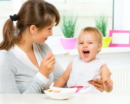 Live-In Nanny feeding Child