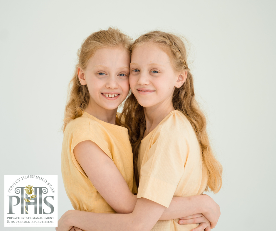 Two sisters hugging warmly, illustrating balancing attention between two children and nurturing their sibling bond..