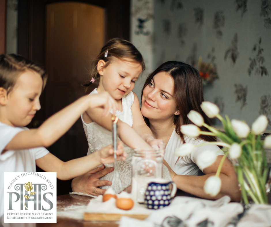 Nanny caring for siblings during tea time, fostering positive sibling relationships and attentive childcare.